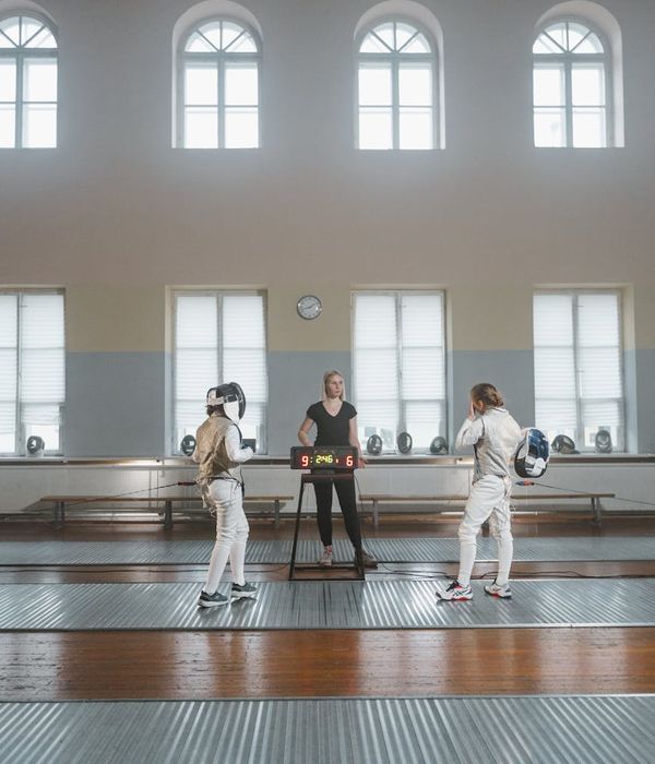 Woman in a light sportswear performing a smooth dynamic exercise.